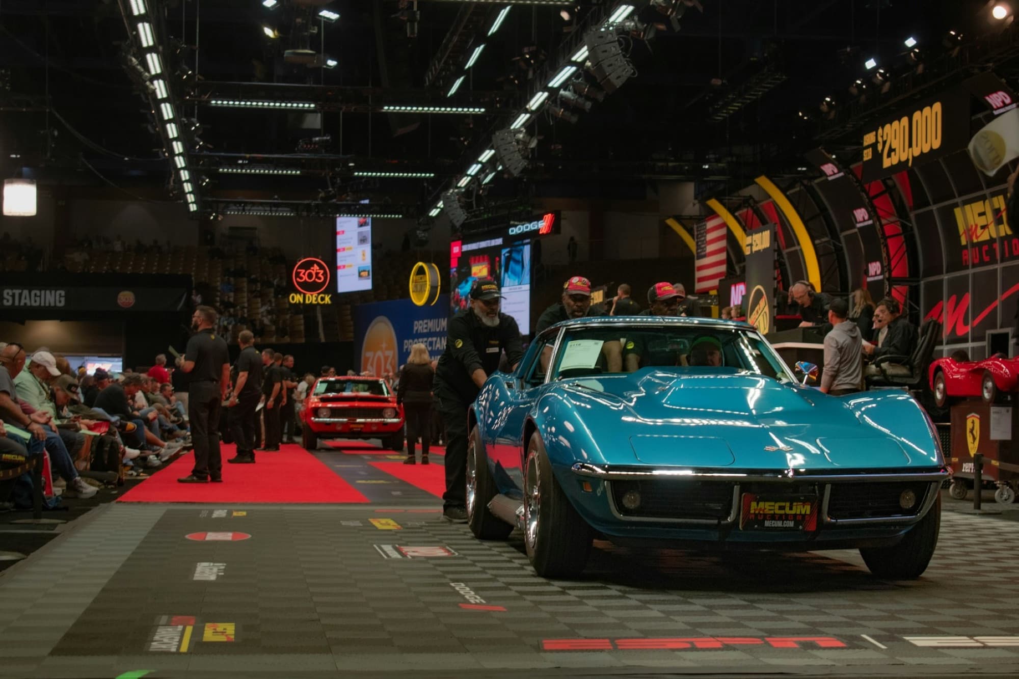 Vehicle moving through a live automotive auction hall
