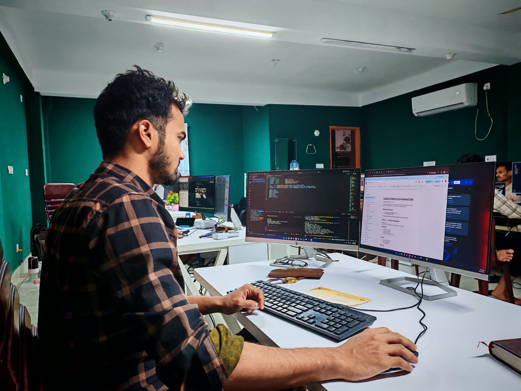 Software developer working across code and delivery planning screens
