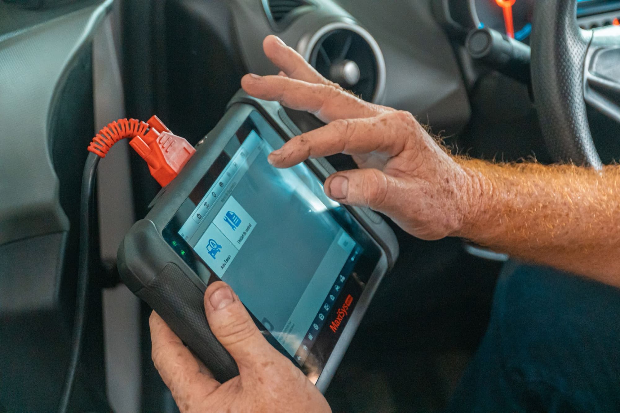 Technician operating a connected vehicle diagnostic system